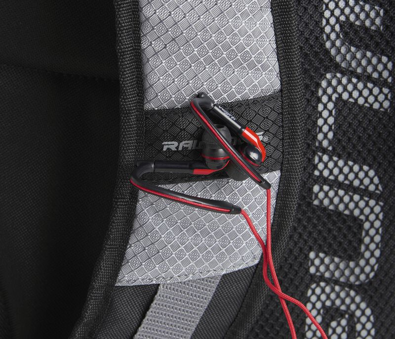 A gray shoulder strap on a R1000 Rawlings Gold Glove Series backpack with headphones attached to the magnet