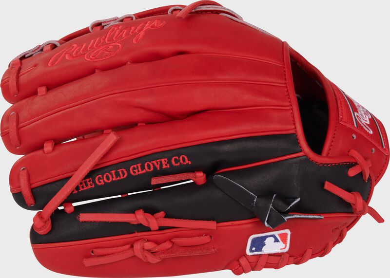 Scarlet/black back of a Corbin Carroll Heart of the Hide Outfield Glove with the MLB logo on the pinky