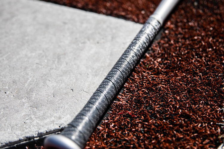 Silver grip of a Rawlings 2020 BBCOR 5150 bat next to home plate - SKU: BBZ53