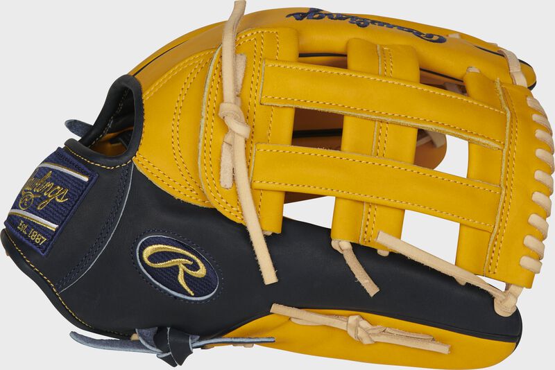 Thumb of a gold tan PROBH3-6GT Heart of the Hide 12.75-inch outfield glove with a navy thumb and gold tan H-web