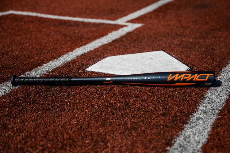 A 2020 Impact BBCOR bat lying next to home plate - SKU: BBZI3