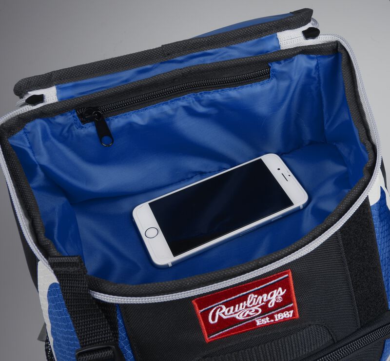Top accessory pocket of a black/royal R500 equipment backpack holding a phone