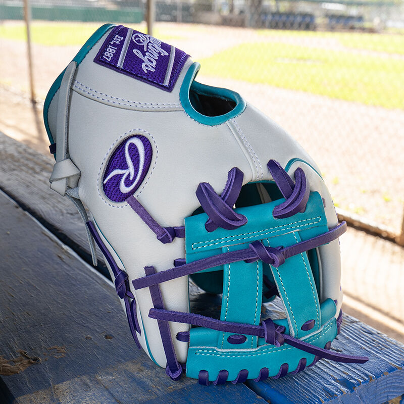 Picture of the teal V-web of a Rawlings exclusive Heart of the Hide R2G Wing Tip 11.5" infield glove standing on its fingertips on a table