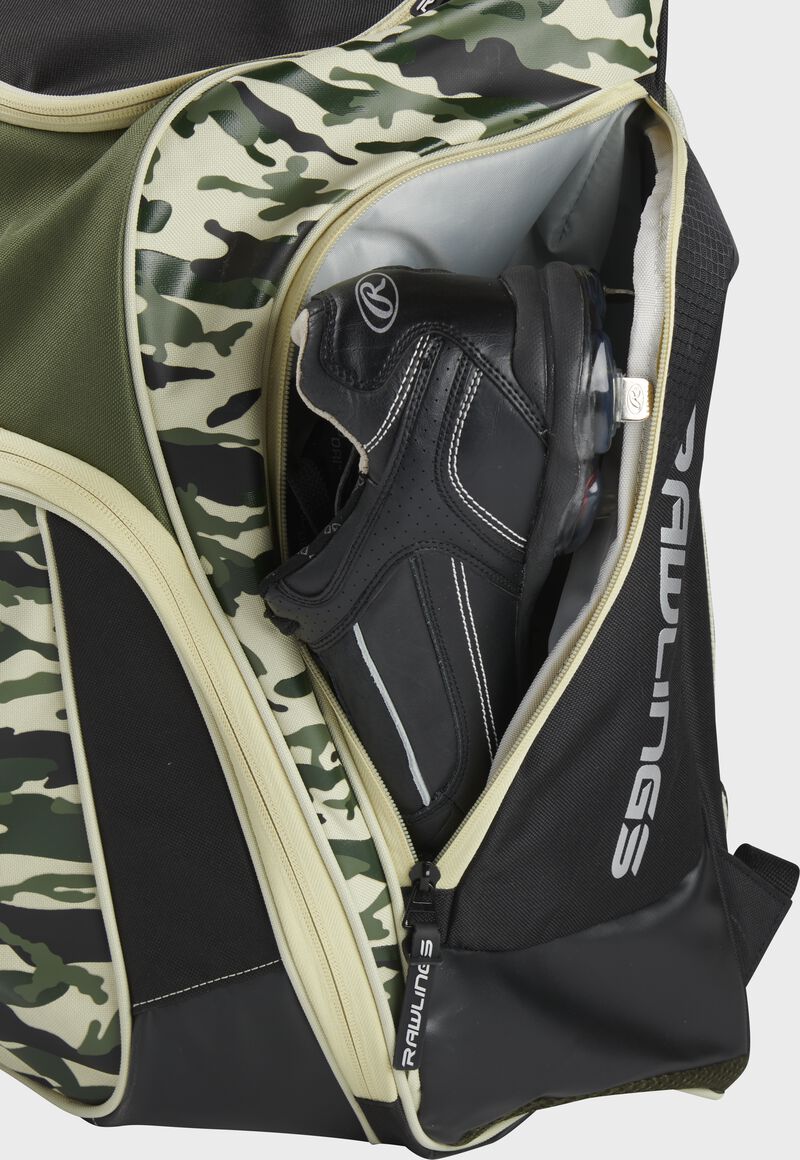 A cleat in the side cleat pocket of a camo Legion baseball backpack - SKU: LEGION-CAMO