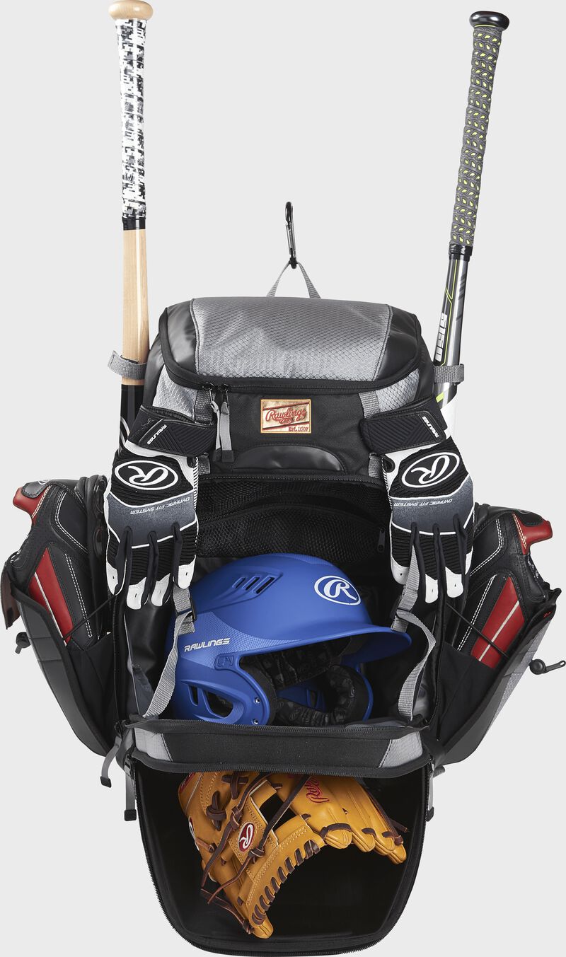 A black/gray R1000 Rawlings Gold Glove bag with the main compartments open and filled with a helmet, glove, bats and cleats