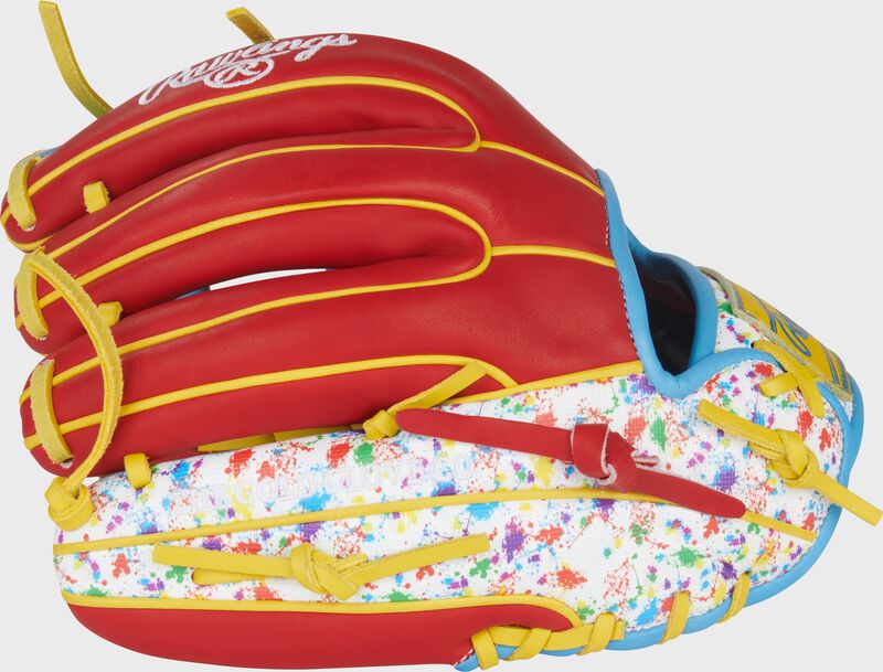 Scarlet back with splatter print pinky of a Heart of the Hide 11.5-Inch Splatter Infield Glove with the MLB logo on the pinky