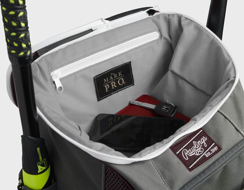Top compartment of a maroon Impulse bag with a phone, keys and black "The Mark of a Pro" patch - SKU: IMPLSE-MA loading=