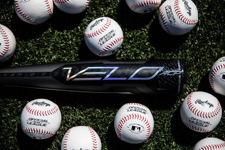 A -10 Velo ACP USA Baseball bat lying on a field next to baseballs - SKU: USZV10