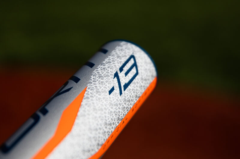 Barrel of a -13 Storm softball bat with a field in the background - SKU: FPZS13