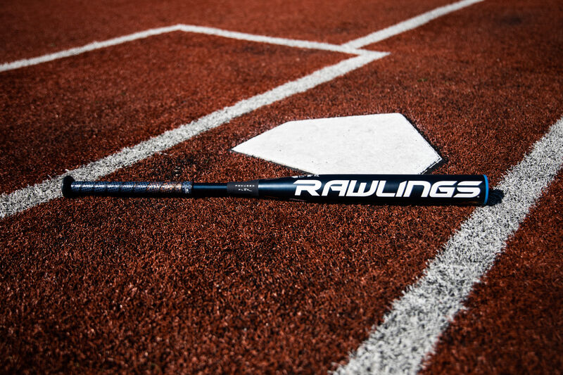 A Rawlings end loaded Quatro Pro bat lying on a field next to home plate - SKU: FPPE10