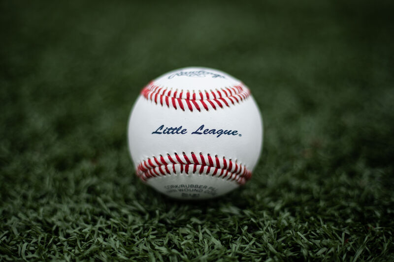 A Rawlings Little League baseball lying in the grass on a field - SKU: RLLB1 loading=