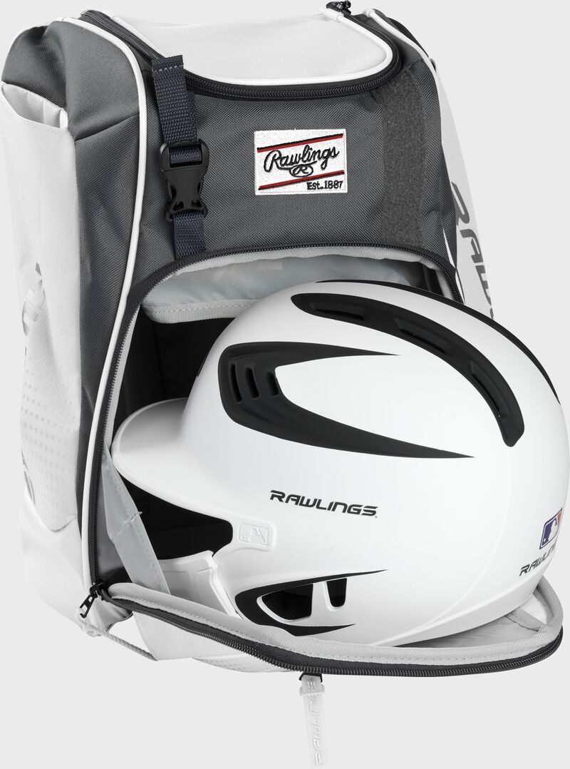 A white/black helmet in the main compartment of a white Rawlings Franchise backpack - SKU: FRANBP-W image number null