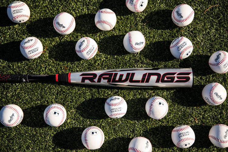 Rawlings logo on the barrel of a USA Quatro Pro bat on a field surrounded by baseballs - SKU: US1Q8