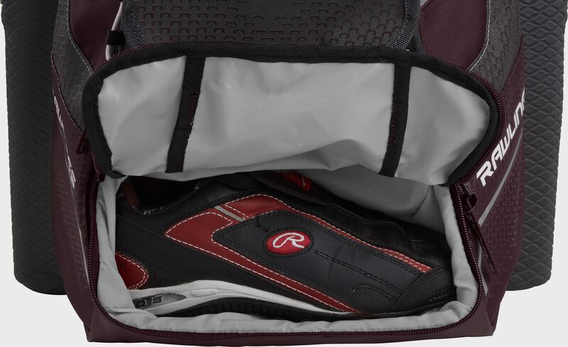 A maroon Rawlings baseball backpack with a cleat in the bottom cleat storage compartment - SKU: IMPLSE-MA