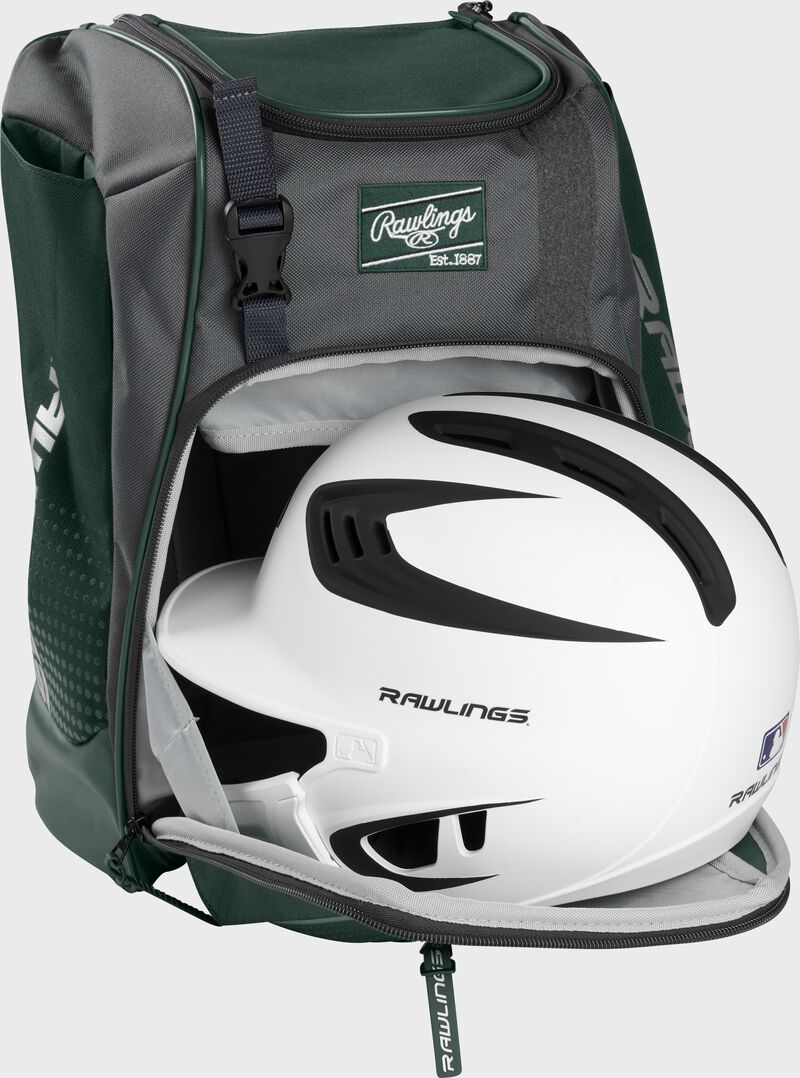 A white/black helmet in the main compartment of a dark green Rawlings Franchise backpack - SKU: FRANBP-DG