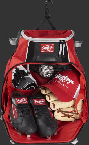 The open main compartment of a VELOBK with cleats, glove, hat, batting gloves and a ball