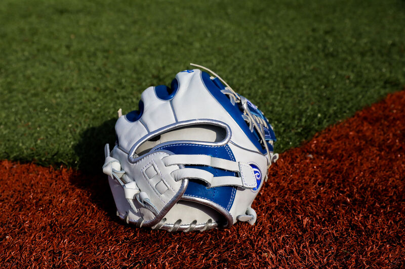 A white/royal Liberty Advanced Color Series infield glove on a field - SKU: RLA715SB-31WRP