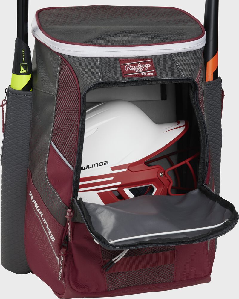 A cardinal Impulse baseball backpack with a helmet in the main compartment - SKU: IMPLSE-C
