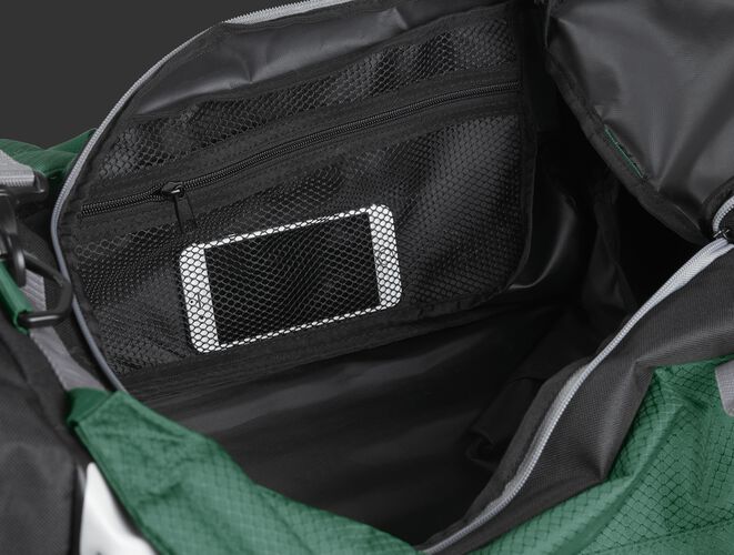 A phone inside the mesh accessory pocket inside the main compartment of a dark green R601 Hybrid bag
