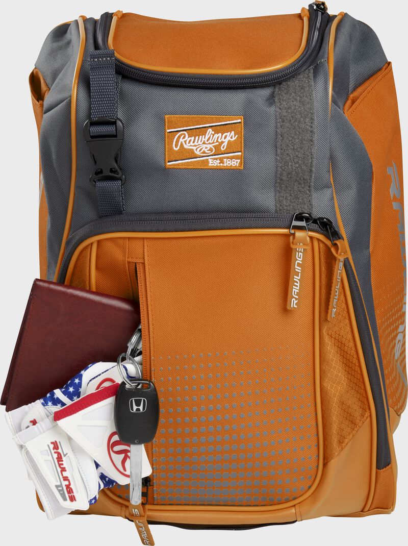 Wallet, keys, and batting gloves in the front valuables pocket of an orange Franchise baseball bag - SKU: FRANBP-O