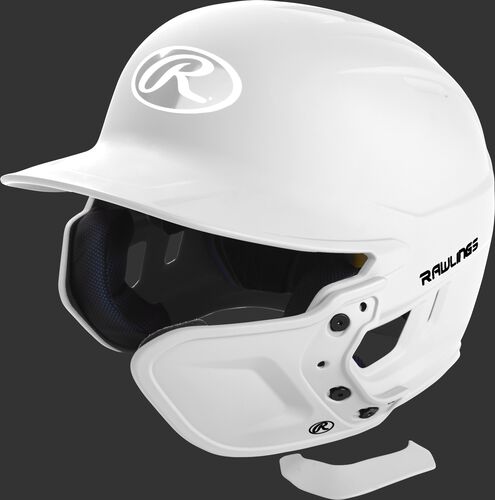 A white MEXTR attached to a Mach batting helmet with the removable TPU piece off to show the hardware