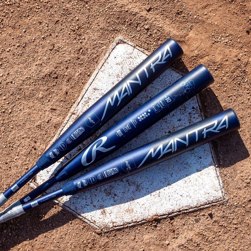 Picture of three navy Mantra fastpitch bats on top of home plate