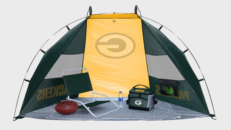 Inside of a Green Bay Packers shelter tent with a chair cooler and ball