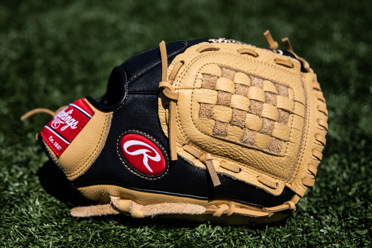 Thumb of a Prodigy 11-Inch Basket Web glove lying on a field - SKU: P110CBB