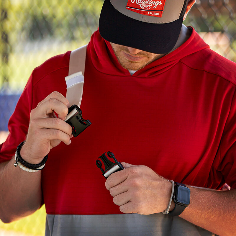 A player strapping a white Rawlings sling bag over his shoulder - SKU: RSLINGBG