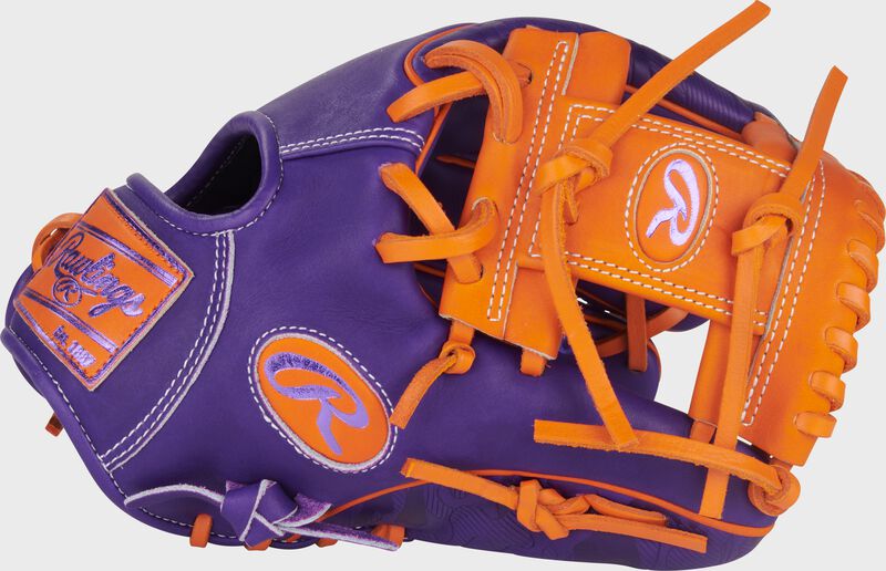 Purple thumb of a Heart of the Hide ContoUR Fit 11.5-Inch Wing Tip Glove with an orange Pro I-web