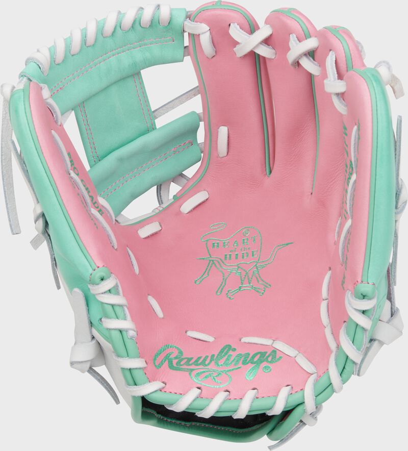 Pink palm of a Heart of the Hide 11.5" Wing Tip glove with mint stamping and white laces