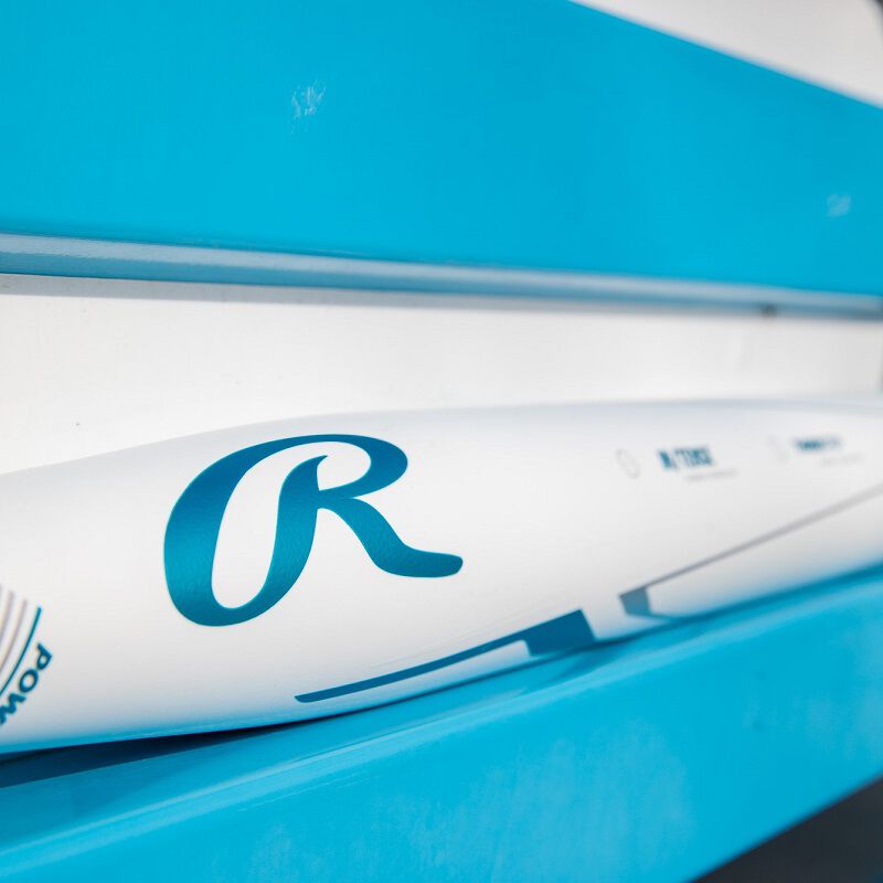 Blue "R" Rawlings logo on the white barrel of a Rawlings 2023 Mantra plus bat sitting on a blue bench - SKU: RFP3MP