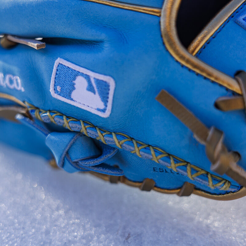 Picture of the MLB logo and hand sewn-welting on a Columbia blue exclusive R2G Heart of the Hide 11.75" glove