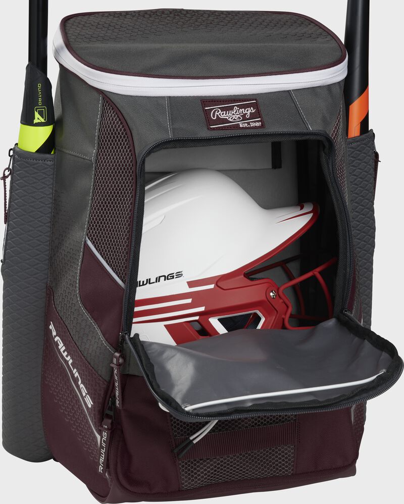 A maroon Impulse baseball backpack with a helmet in the main compartment - SKU: IMPLSE-MA image number null