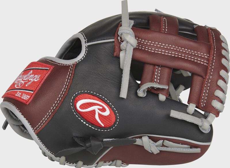 Thumb view of a black R9TR 9.5-inch Rawlings R9 infield training glove with sherry trim and a sherry single post web.