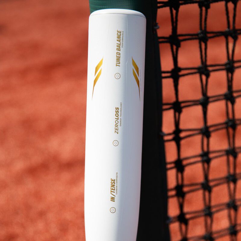 White barrel with gold tech callouts on the barrel of an Icon USSSA bat on a field - SKU: RUT4I