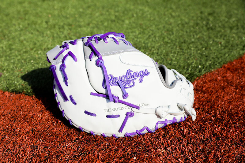A Rawlings Liberty Advanced Color Series 1st base mitt on a field - SKU: RLADCTSBWPG