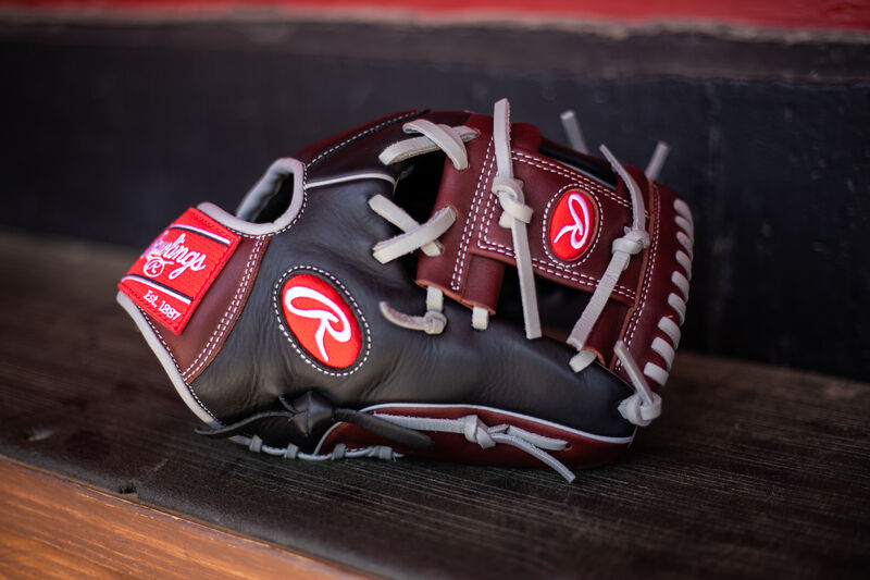 A R9 Series I-web glove sitting on the bench in a dugout - SKU: R9204-2BSG