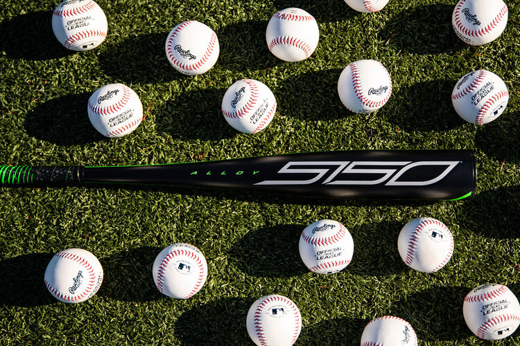 A Rawlings 2021 5150 USSSA baseball bat on a field with baseballs around it - SKU: UT1510