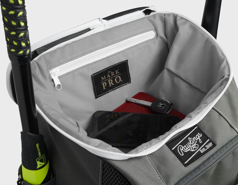 Top compartment of a black Impulse bag with a phone, keys and black "The Mark of a Pro" patch - SKU: IMPLSE-B loading=
