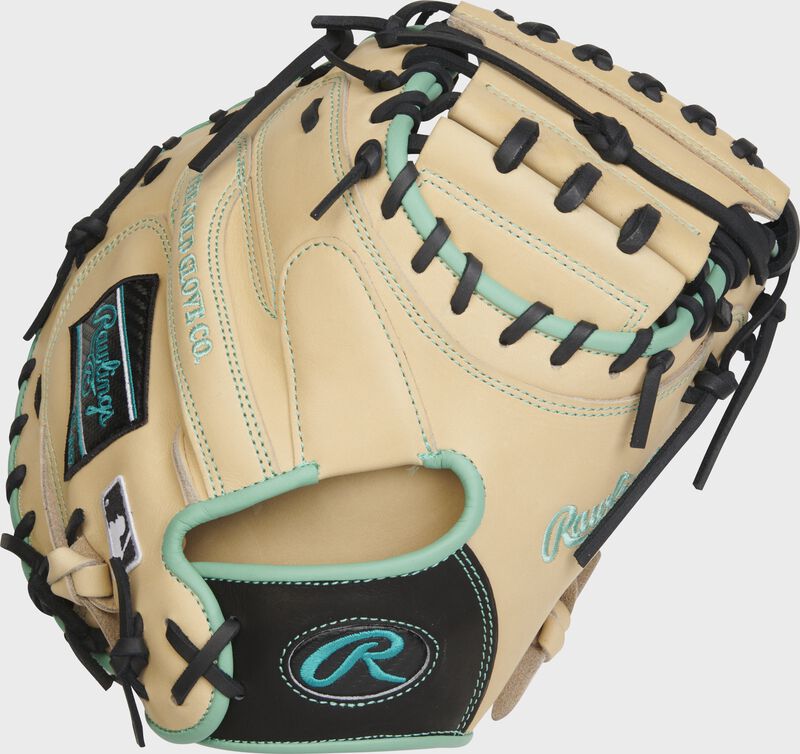 Back of a camel Heart of the Hide 33" catcher's mitt with a black/mint Oval-R logo on the wrist strap - SKU: PROCM33CBM