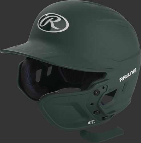 A matte dark green MEXT attached to a Mach batting helmet showing the hardware