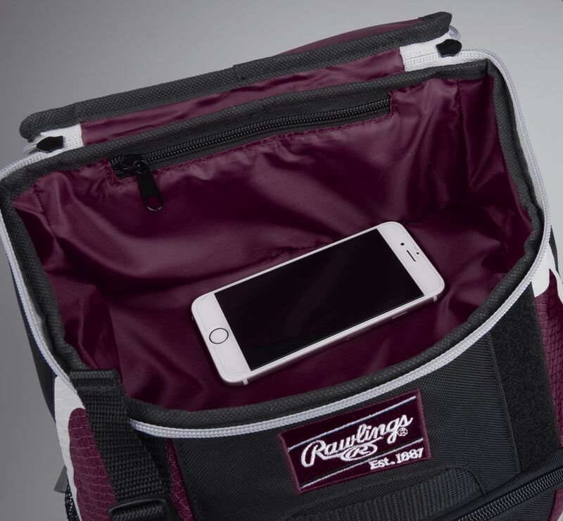 Top accessory pocket of a black/maroon R500 equipment backpack holding a phone