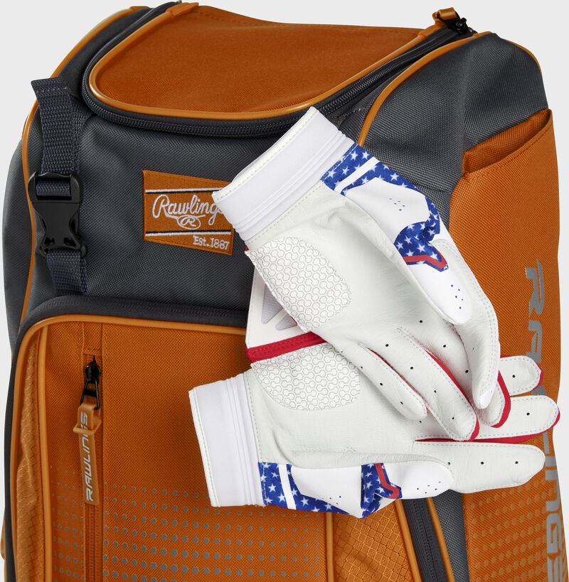 Two batting gloves hanging on the front Velcro strap of a Franchise baseball backpack - SKU: FRANBP-O