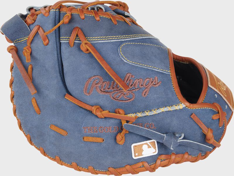 Back of a Heart of the Hide Pro Label Denim 1st base mitt with the MLB logo on the pinky