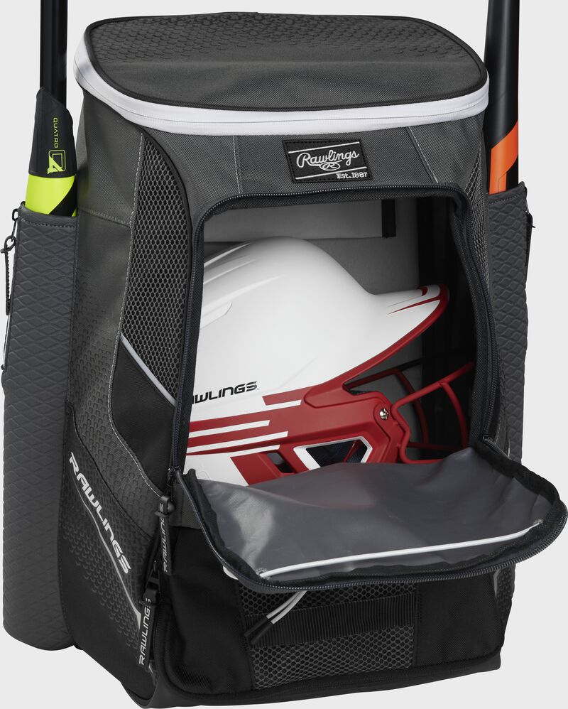 A black Impulse baseball backpack with a helmet in the main compartment - SKU: IMPLSE-B