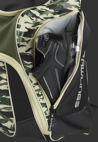 A cleat in the side cleat pocket of a camo Legion baseball backpack - SKU: LEGION-CAMO