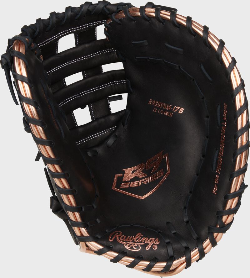 Black palm of a Rawlings R9 Series fastpitch first base mitt with rose gold stamping and black laces