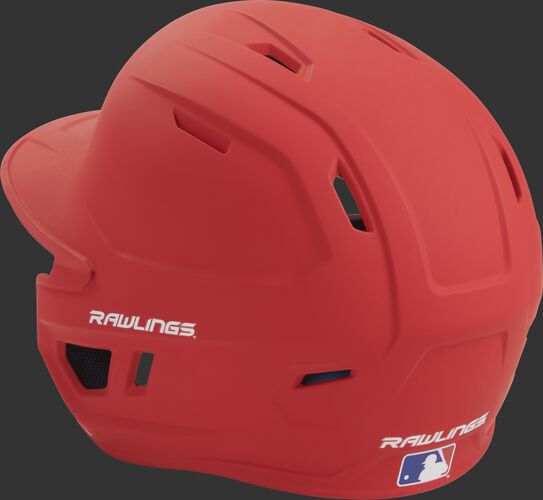 Back left view of a matte scarlet MACH series batting helmet with air vents