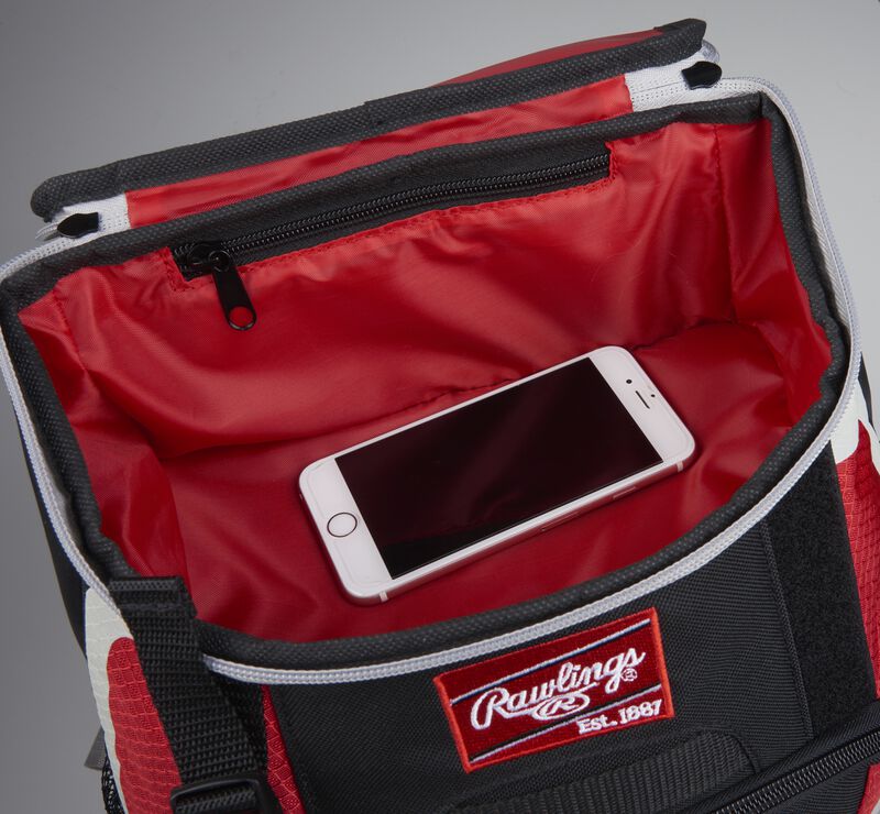 Top accessory pocket of a black/scarlet R500 equipment backpack holding a phone